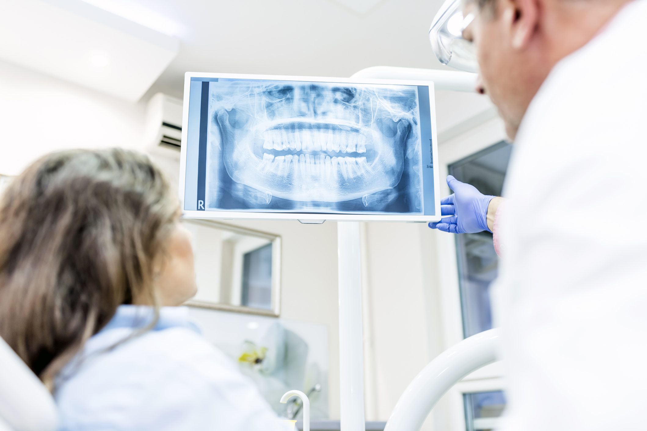 Photo of Dentist showing patient x-ray Photo of Dentist showing patient x-ray