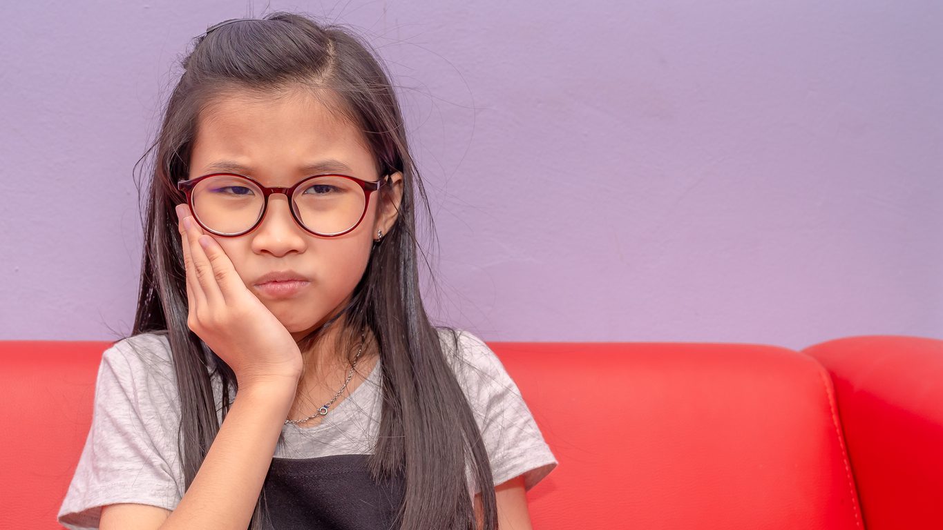 Photo of an Asian girl having toothache