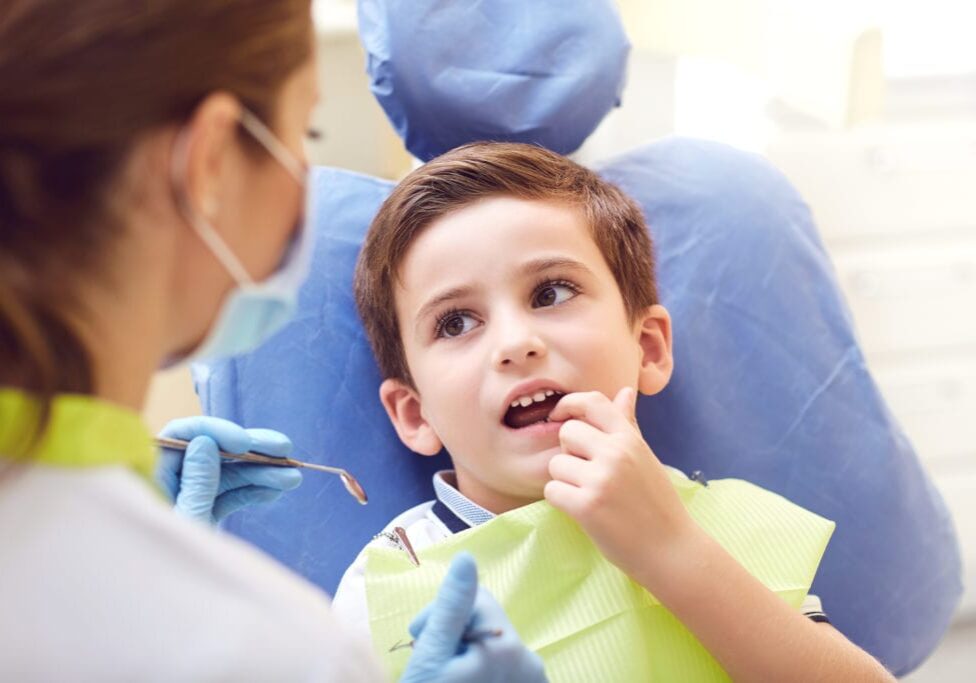 A child with a dentist in a dental office.