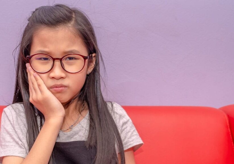 Photo of an Asian girl having toothache